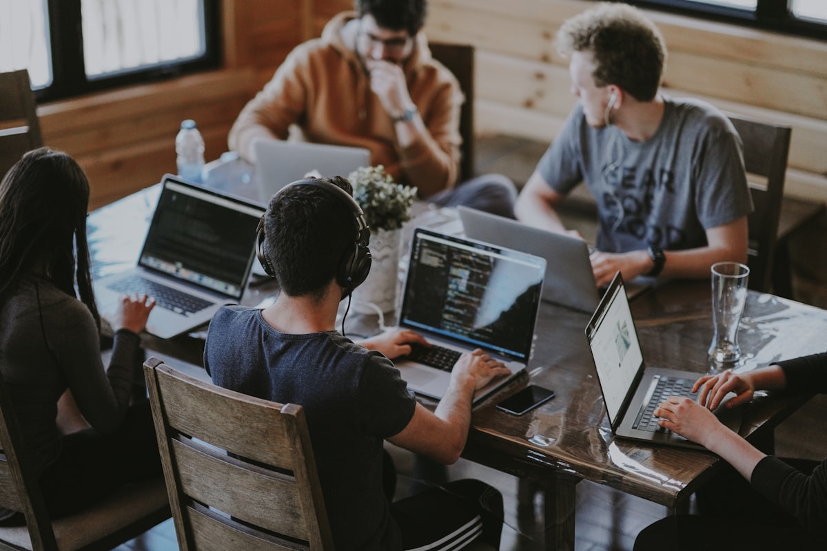 A SaaS team collaborating around a laptop