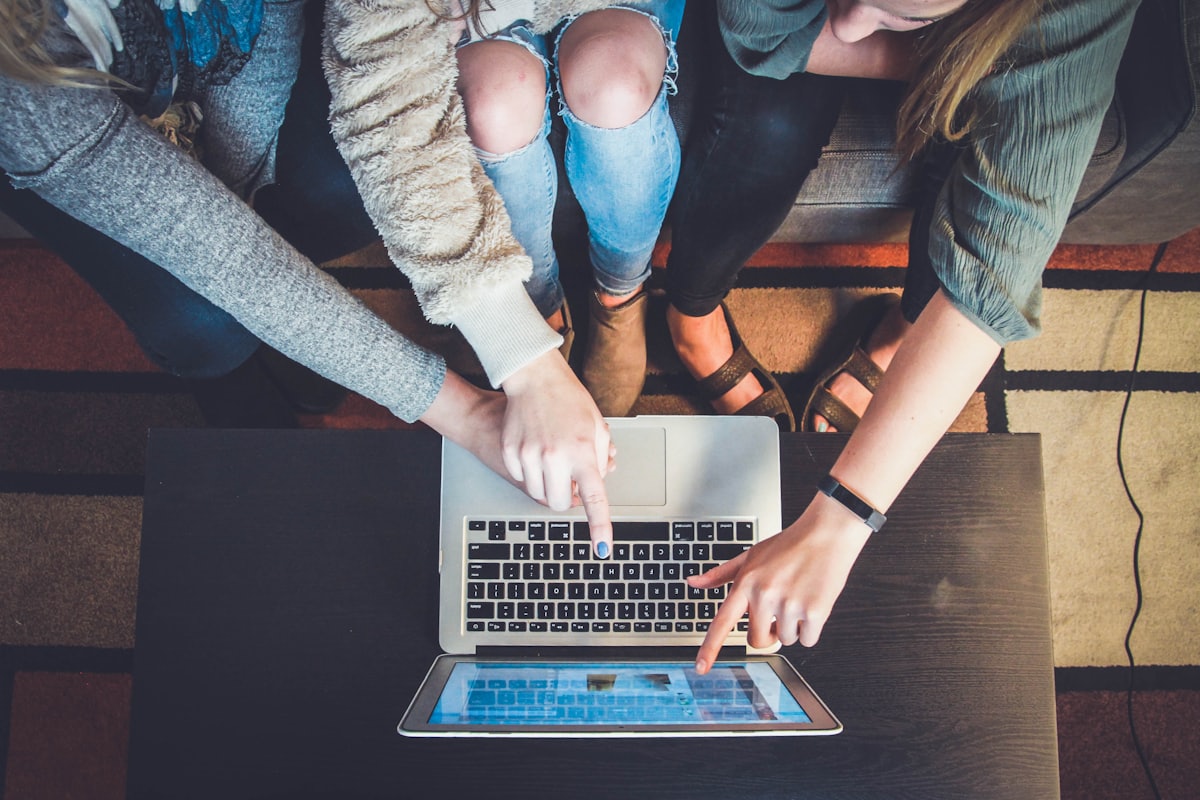 Students learning around a laptop